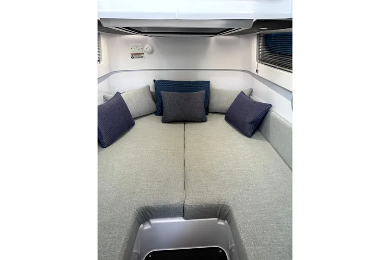  Yacht Photos Pics 2024 Axopar 37 XC CROSS CABIN interior with cozy seating and cushions.