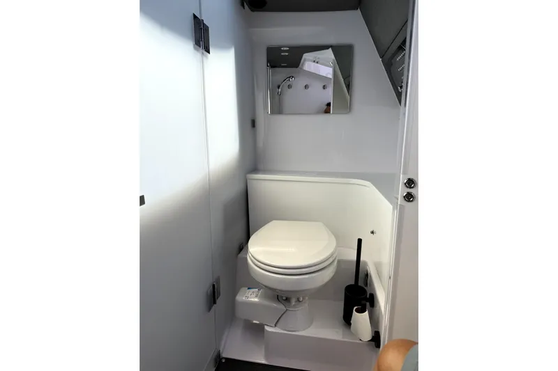  Yacht Photos Pics 2024 Axopar 37 XC CROSS CABIN bathroom with toilet and mirror.
