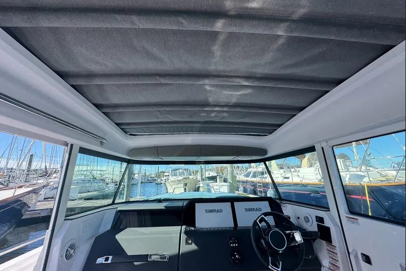  Yacht Photos Pics 2024 Axopar 37 XC CROSS CABIN interior with panoramic windows and modern dashboard.