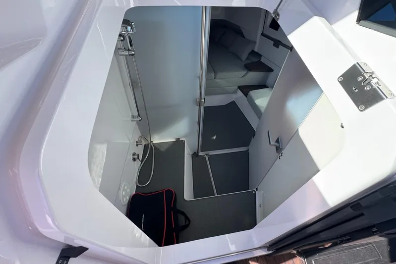  Yacht Photos Pics 2024 Axopar 37 XC CROSS CABIN interior with modern shower and seating area.