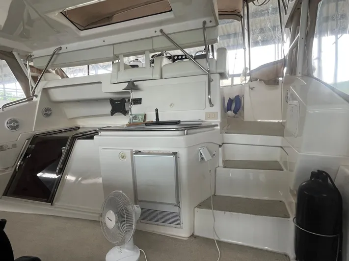  Yacht Photos Pics 1999 Silverton 392 Aft Cabin interior with stairs, fan, and seating area.