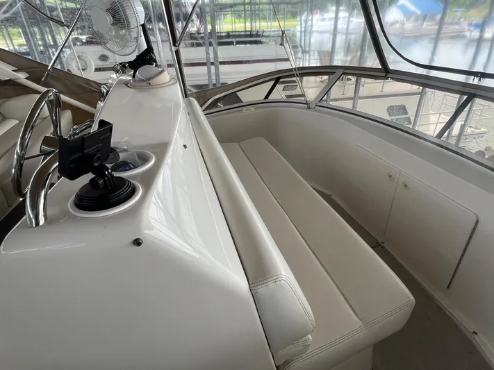  Yacht Photos Pics 1999 Silverton 392 Aft Cabin interior with helm, seating, and panoramic windows.