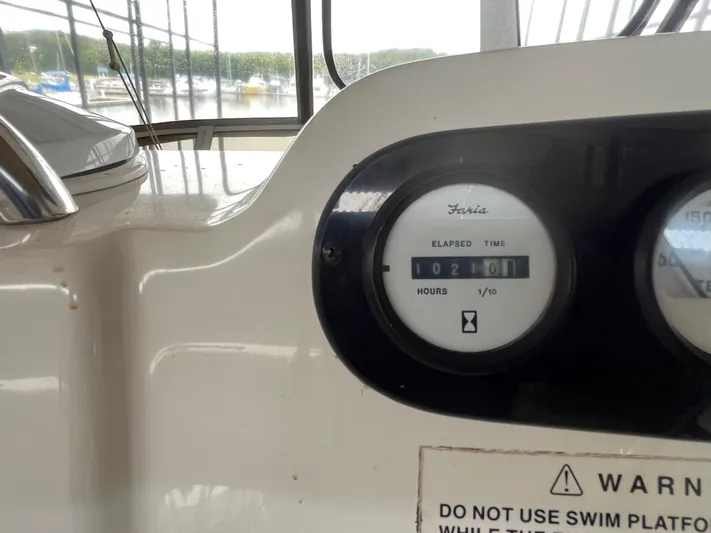  Yacht Photos Pics 1999 Silverton 392 Aft Cabin boat dashboard with elapsed time gauge reading 1021 hours.