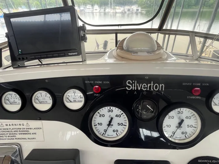  Yacht Photos Pics Control panel of a 1999 Silverton 392 Aft Cabin yacht with gauges and navigation equipment.