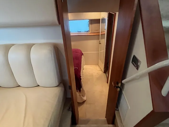  Yacht Photos Pics Interior view of 1999 Silverton 392 Aft Cabin, featuring cozy seating and hallway.