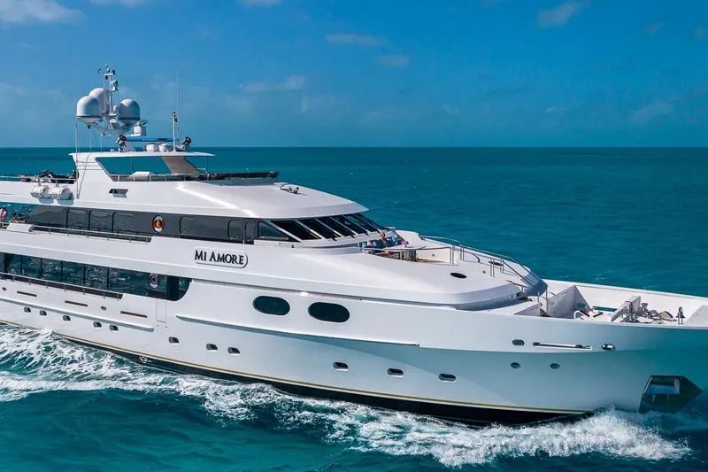Amore Yacht Photos Pics Luxurious 2005 Christensen motor yacht cruising on clear blue ocean waters.