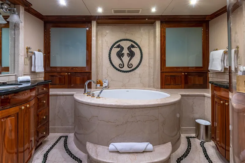 Amore Yacht Photos Pics Luxurious yacht bathroom with marble jacuzzi, seahorse mosaic, and elegant wood cabinetry, 2005 Christensen model.
