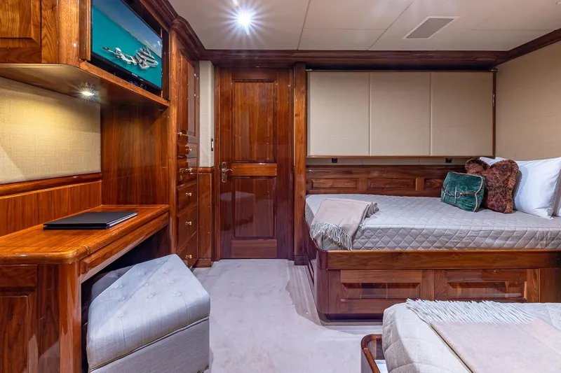 Amore Yacht Photos Pics Luxurious 2005 Christensen motor yacht cabin with elegant wood finishes and cozy bedding.
