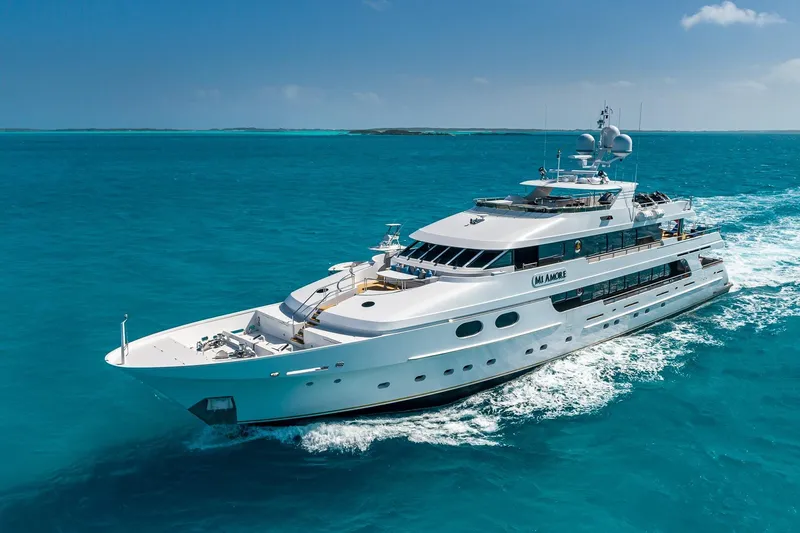 Amore Yacht Photos Pics Luxurious 2005 Christensen motor yacht cruising in clear blue ocean waters.