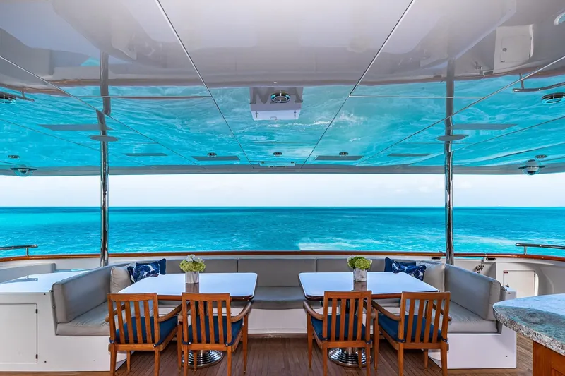 Amore Yacht Photos Pics Luxurious 2005 Christensen motor yacht deck with ocean view and elegant dining setup.