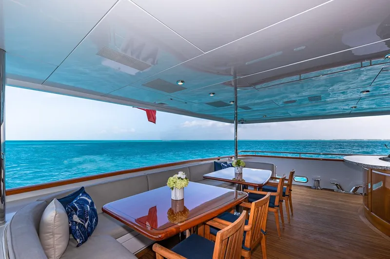 Amore Yacht Photos Pics Luxurious 2005 Christensen motor yacht deck with ocean view, elegant seating, and dining area.