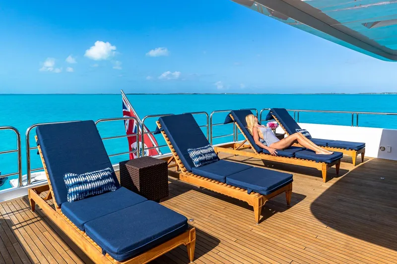 Amore Yacht Photos Pics Luxurious 2005 Christensen motor yacht deck with sun loungers and ocean view.