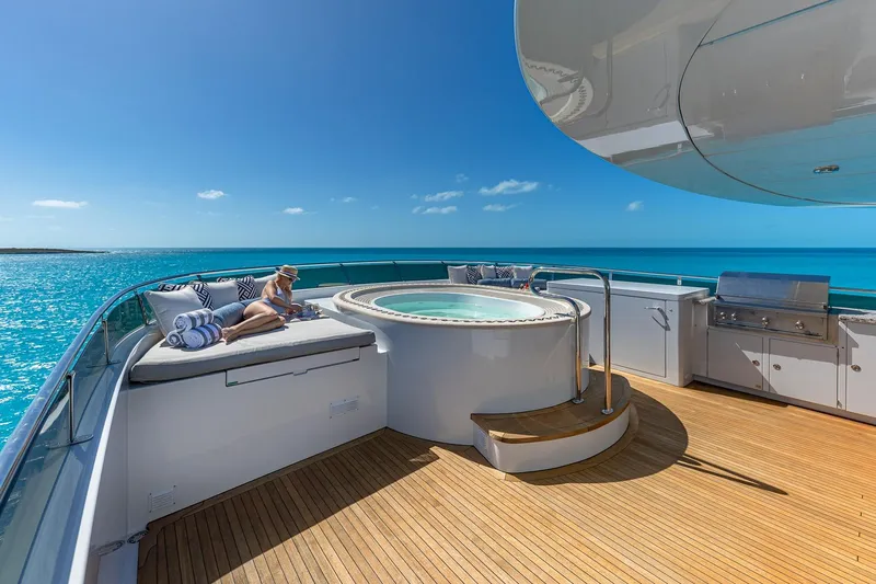 Amore Yacht Photos Pics Luxurious 2005 Christensen motor yacht deck with jacuzzi and sunbathing area.