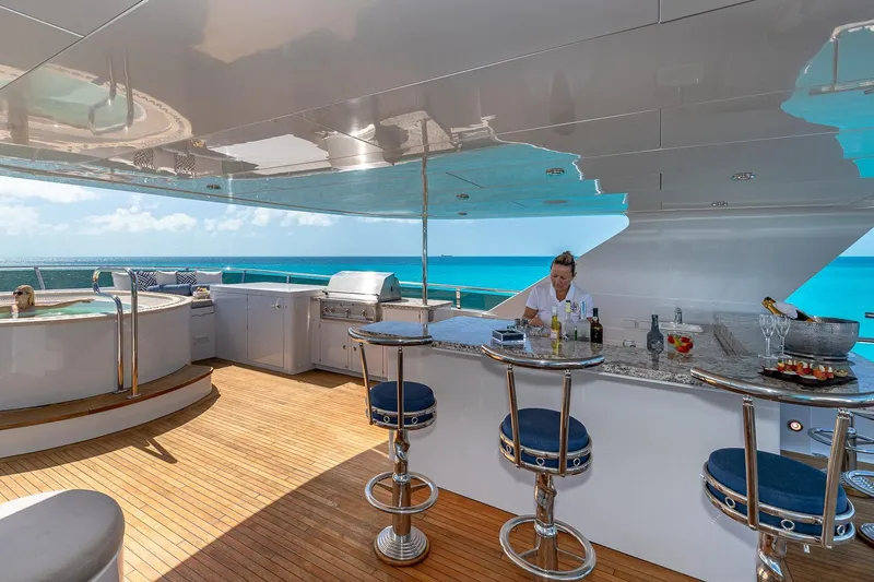 Amore Yacht Photos Pics Luxurious 2005 Christensen motor yacht deck with bar, jacuzzi, and ocean view.