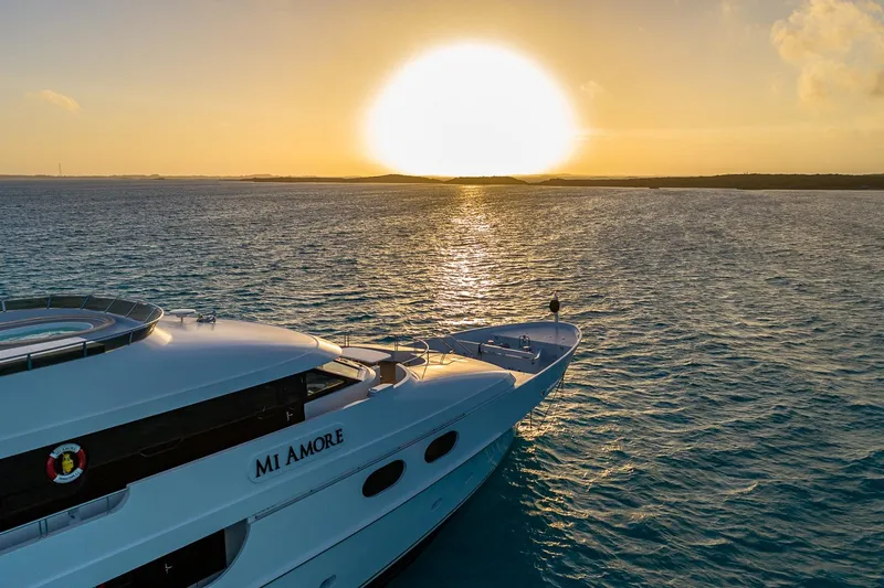 Amore Yacht Photos Pics Luxurious 2005 Christensen motor yacht at sunset on tranquil ocean waters.