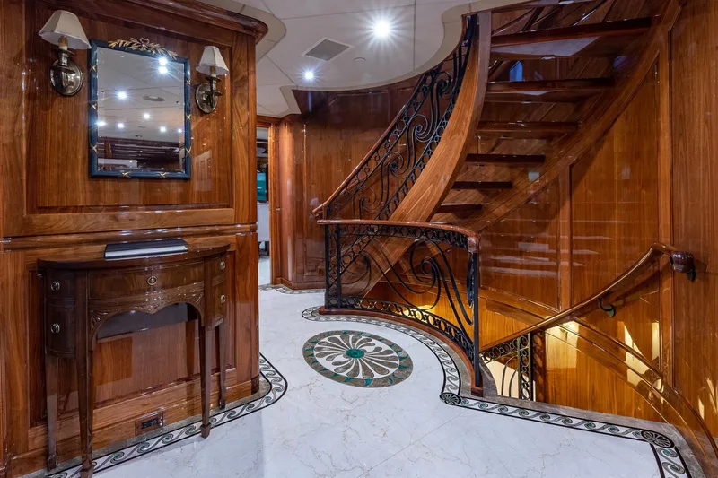 Amore Yacht Photos Pics Luxurious wooden interior of 2005 Christensen motor yacht with elegant staircase and ornate decor.