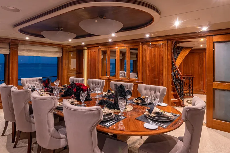 Amore Yacht Photos Pics Luxurious dining area on 2005 Christensen motor yacht with elegant table setting and plush seating.