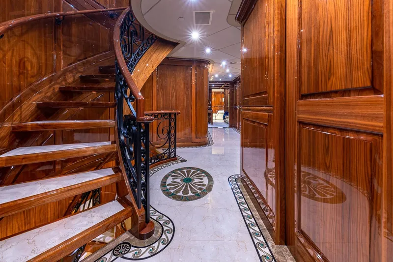Amore Yacht Photos Pics Luxurious wooden interior of 2005 Christensen motor yacht with elegant staircase and intricate flooring.