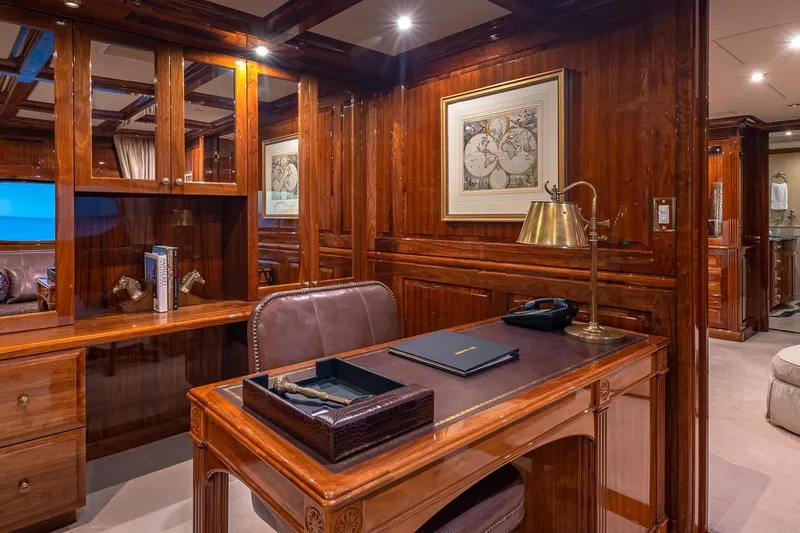 Amore Yacht Photos Pics Luxurious wooden office interior on 2005 Christensen motor yacht, featuring elegant desk and decor.