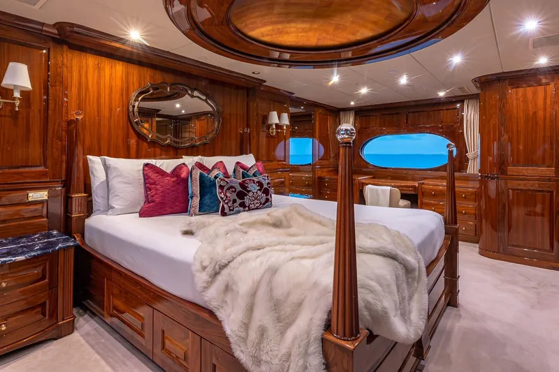 Amore Yacht Photos Pics Luxurious 2005 Christensen motor yacht bedroom with elegant wood finishes and plush bedding.