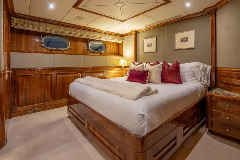 Amore Yacht Photos Pics Luxurious bedroom interior on a 2005 Christensen motor yacht, featuring elegant wood paneling and plush bedding.