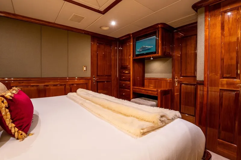 Amore Yacht Photos Pics Luxurious bedroom interior on 2005 Christensen motor yacht with elegant wood paneling.