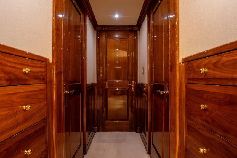 Amore Yacht Photos Pics Luxurious wooden hallway interior of 2005 Christensen motor yacht, featuring polished cabinetry and elegant design.
