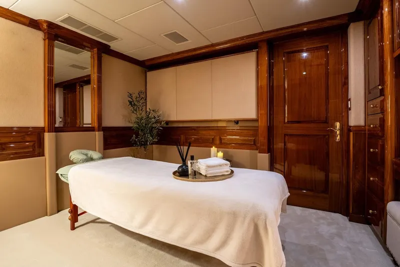 Amore Yacht Photos Pics Luxurious spa room on 2005 Christensen motor yacht with massage table and elegant wood finishes.