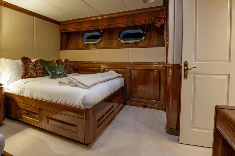 Amore Yacht Photos Pics Luxurious bedroom interior on 2005 Christensen Motor Yacht with elegant wood paneling.