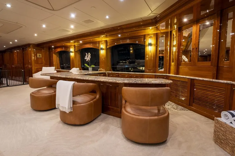 Amore Yacht Photos Pics Luxurious interior of 2005 Christensen motor yacht with elegant wood paneling and plush seating.
