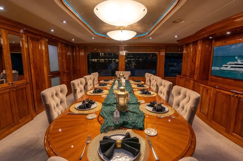 Amore Yacht Photos Pics Luxurious dining area on 2005 Christensen motor yacht with elegant wood finish and ambient lighting.