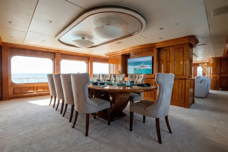 Amore Yacht Photos Pics Luxurious dining area on a 2005 Christensen motor yacht with elegant wood paneling.