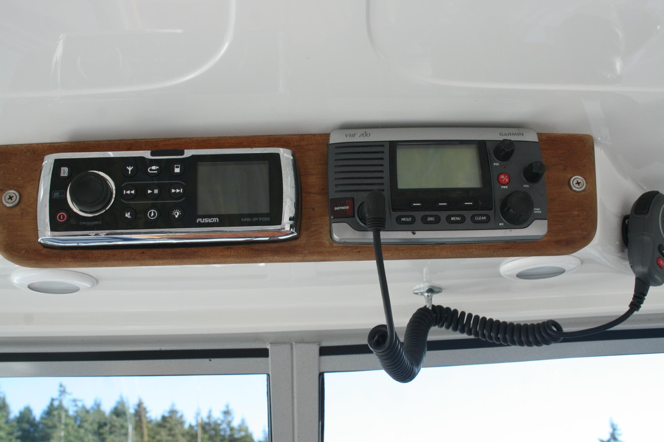 Boat dashboard with Fusion stereo and Garmin VHF radio on a 2012 Protector Targa 30.