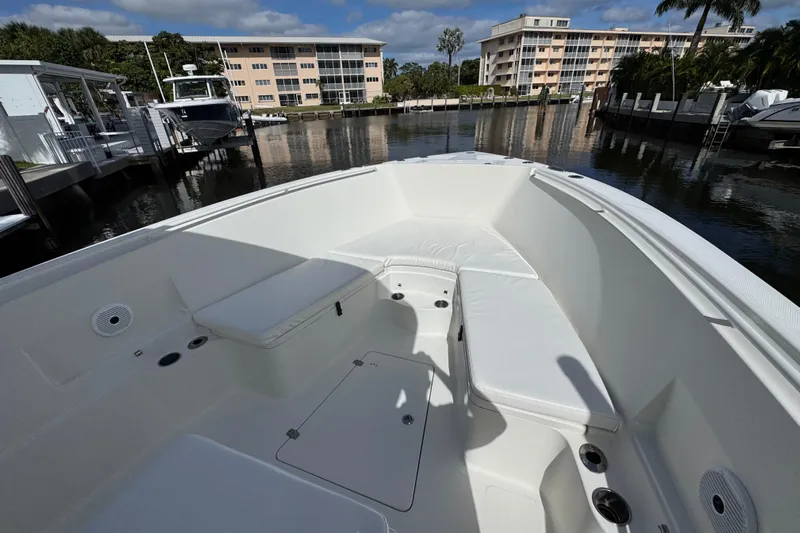  Yacht Photos Pics 2016 Sailfish 320 CC boat interior with white seating, docked near waterfront buildings.