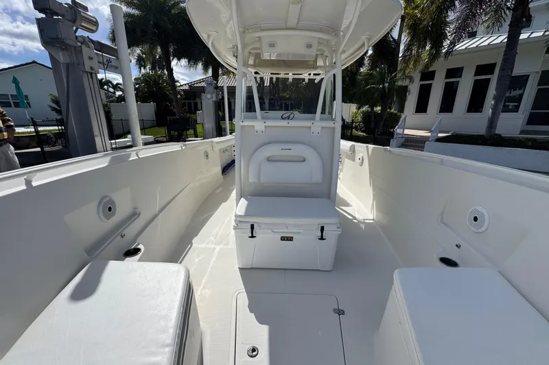  Yacht Photos Pics 2016 Sailfish 320 CC boat interior with seating and storage, docked near palm trees.