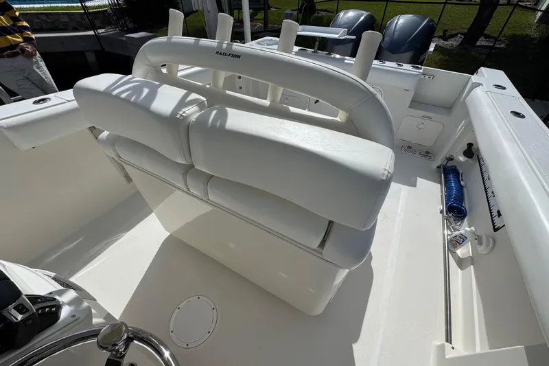  Yacht Photos Pics 2016 Sailfish 320 CC boat interior with white seating and fishing equipment.