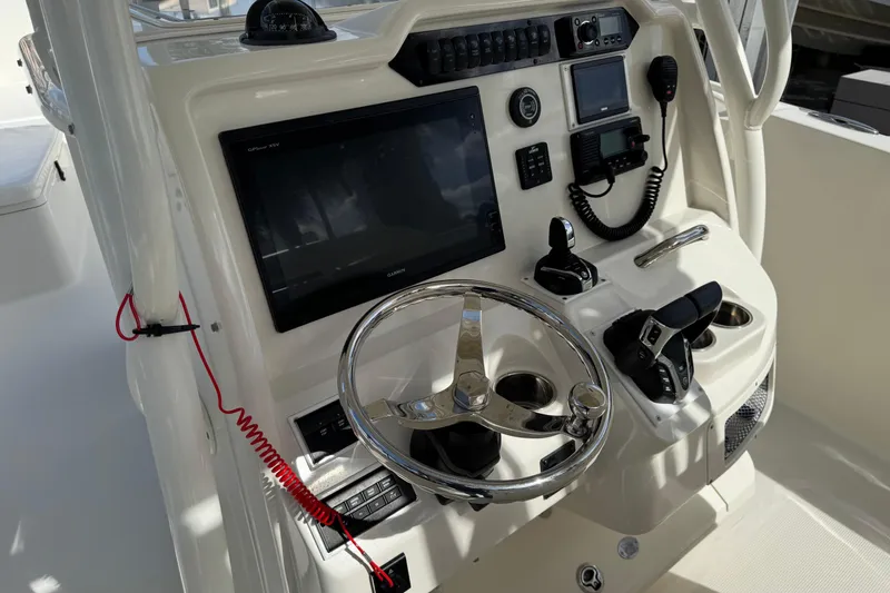  Yacht Photos Pics 2016 Sailfish 320 CC boat dashboard with steering wheel, navigation screens, and controls.