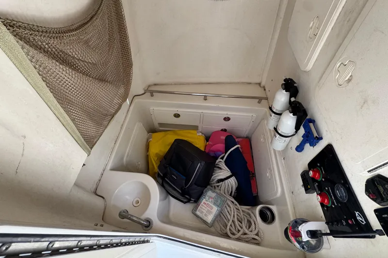  Yacht Photos Pics Interior of 2016 Sailfish 320 CC boat with storage, safety gear, and fire extinguishers.
