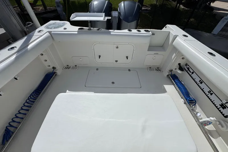  Yacht Photos Pics 2016 Sailfish 320 CC boat deck with storage compartments and coiled hoses.