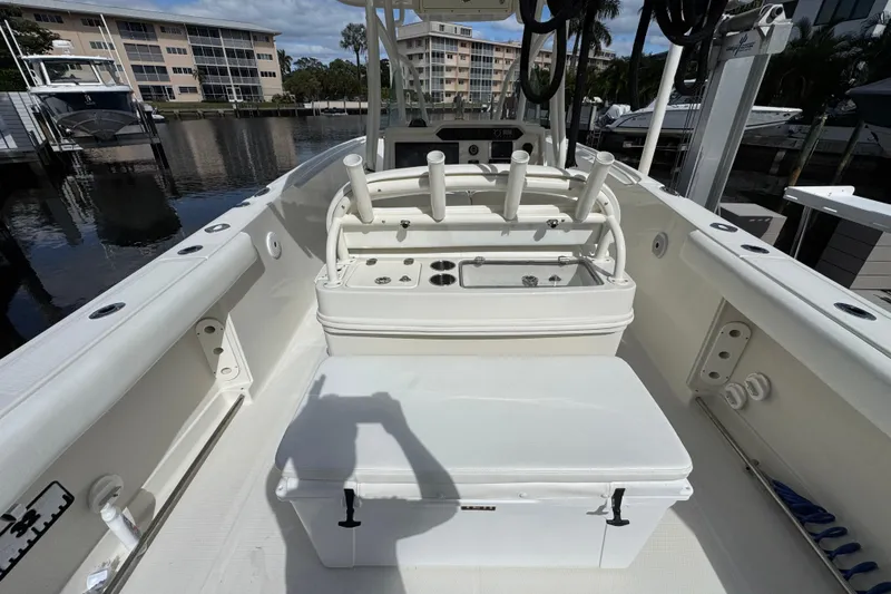  Yacht Photos Pics 2016 Sailfish 320 CC boat interior with fishing rod holders and storage, docked at marina.