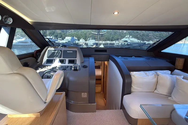  Yacht Photos Pics Luxurious interior of 2013 Ferretti 620 yacht with helm and seating area.