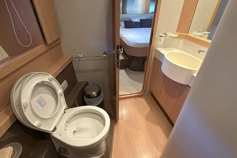  Yacht Photos Pics Bathroom interior of 2013 Ferretti 620 yacht, featuring modern fixtures and wooden accents.
