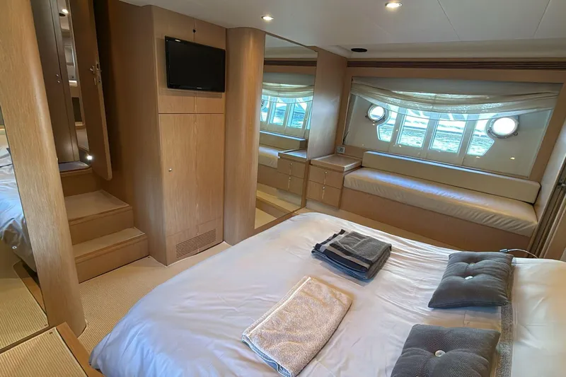  Yacht Photos Pics Luxurious Ferretti 620 yacht bedroom interior, 2013 model, featuring elegant wood finishes and cozy seating.