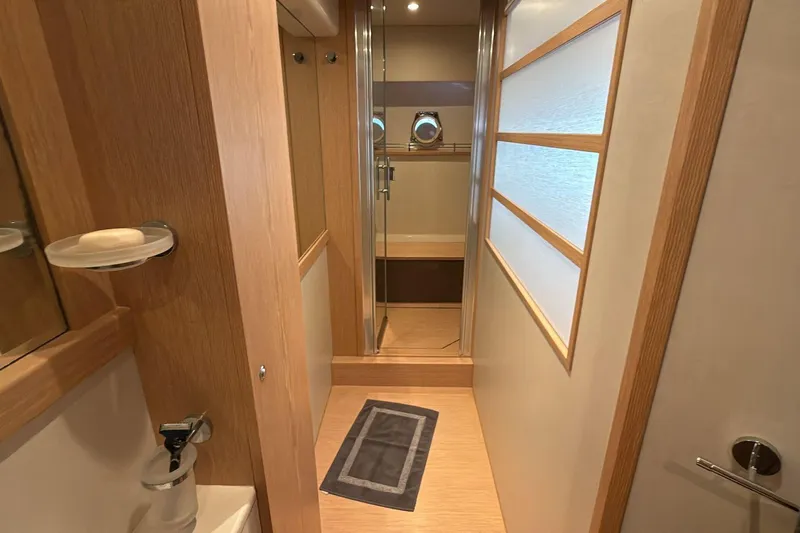  Yacht Photos Pics Luxurious bathroom interior of 2013 Ferretti 620 yacht with modern wood accents.