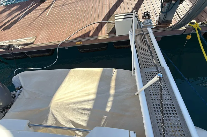  Yacht Photos Pics Ferretti 620 yacht gangway leading to dock, 2013 model, with covered deck area.