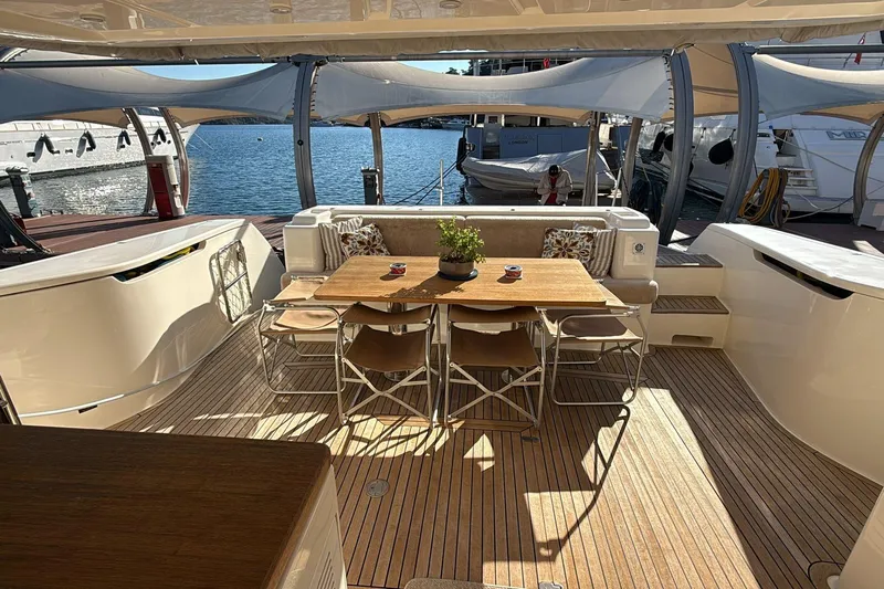  Yacht Photos Pics Luxurious 2013 Ferretti 620 yacht deck with elegant dining area and scenic marina view.