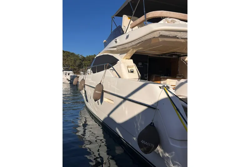  Yacht Photos Pics 2013 Ferretti 620 yacht docked in a serene marina under clear blue skies.