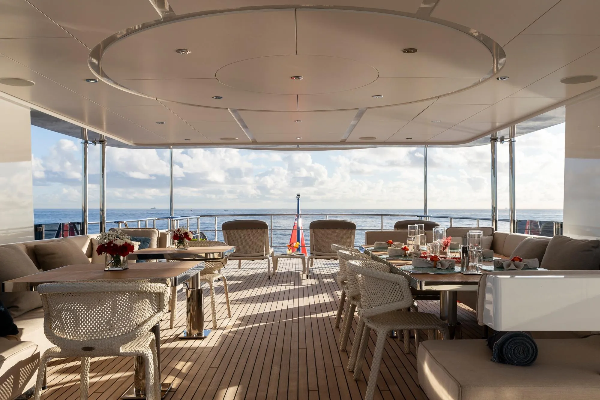 Luxurious 2016 Feadship Lagoon Cruiser deck with elegant dining setup and ocean view.