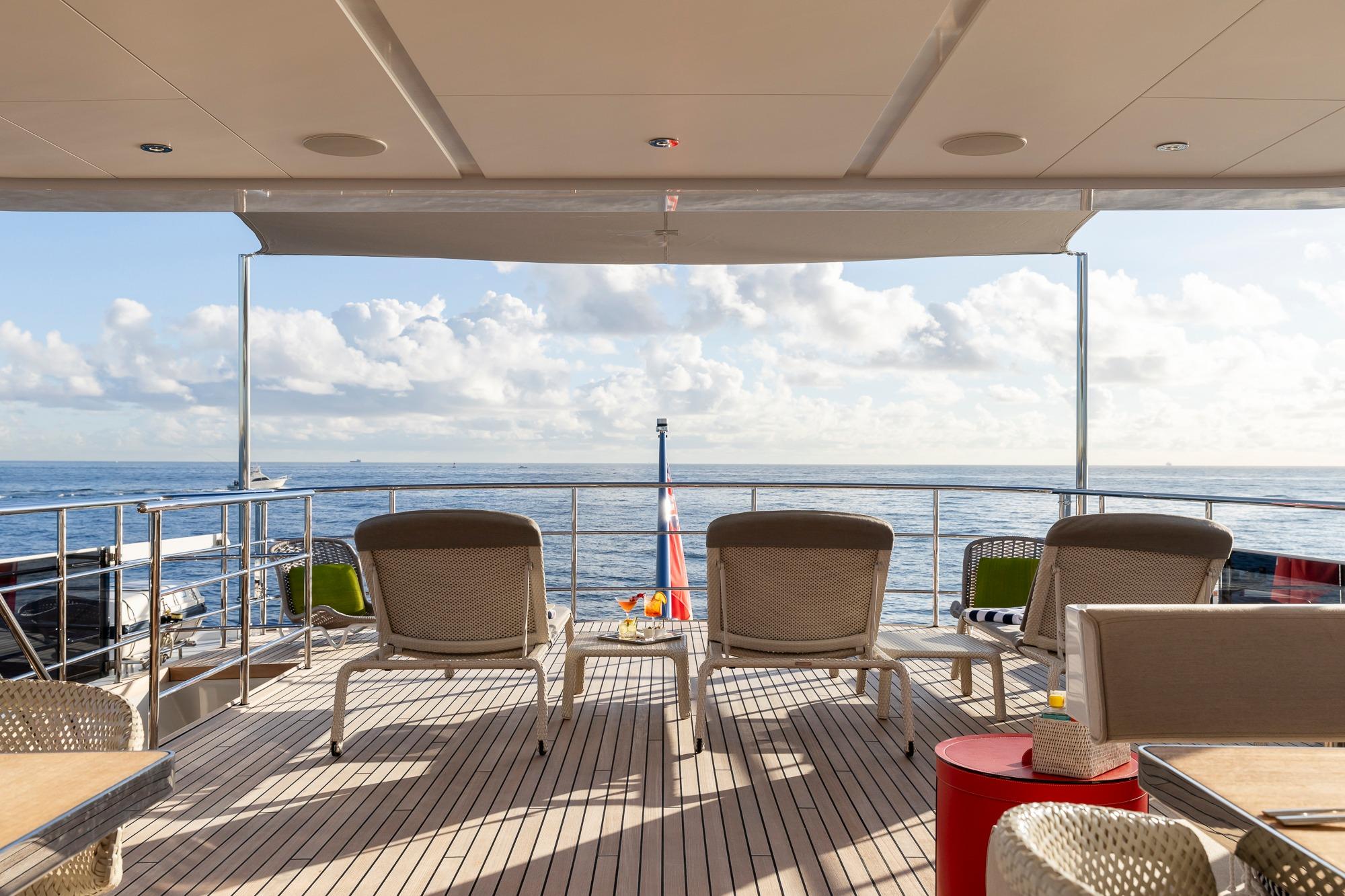 Luxury deck of 2016 Feadship Lagoon Cruiser with ocean view and seating.