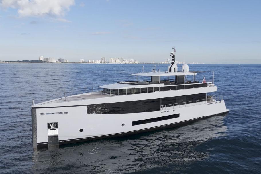 2016 Feadship Lagoon Cruiser (FLC) yacht on open sea with city skyline in background.